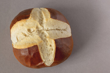 Freshly baked traditional Bavarian laugenbrot on a gray background