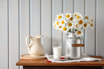 summer still life, daisies in a can against a white wall in a cottage. © Masquerade