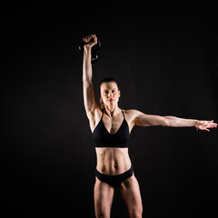 Slim, woman and kettlebell in workout for fitness, exercise and wellness with weight in studio.