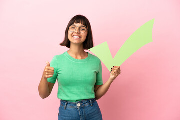 Youing woman holding a check icon with thumb up