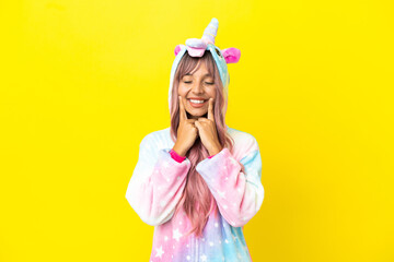 Young mixed race woman wearing a unicorn pajama isolated on white background smiling with a happy and pleasant expression