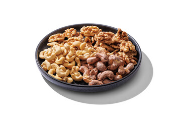 A plate of cashews and walnut kernels. On transparent background with transparent shadow.