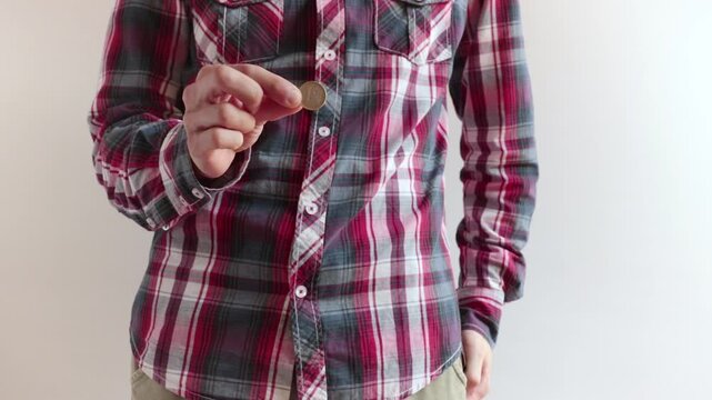 man pulls out a coin of one euro and shows it