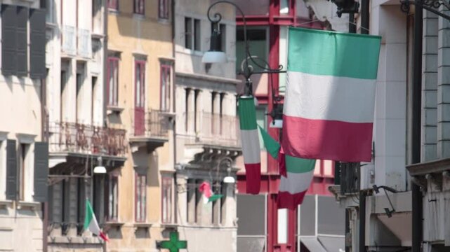 italian flags waving in the main street of udine