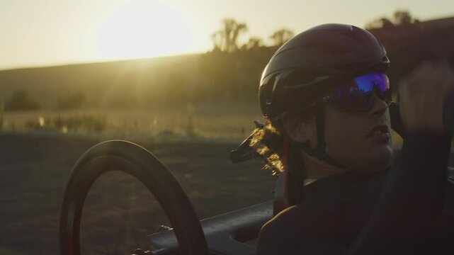 Para Athlete cycling at sunset