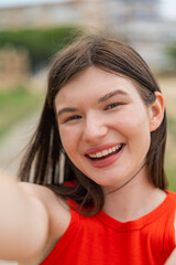 Young pretty woman at outdoors With happy expression