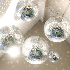 The background of the sparkling silver ball reflects the light