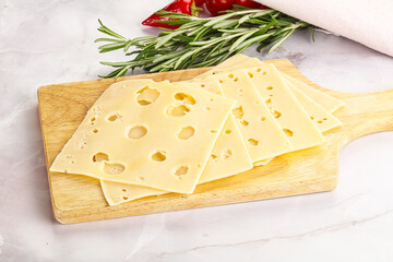 Sliced maasdam cheese with holes