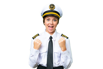 Airplane pilot woman over isolated chroma key background celebrating a victory in winner position