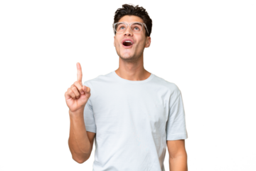 Young caucasian handsome man over isolated background pointing up and surprised