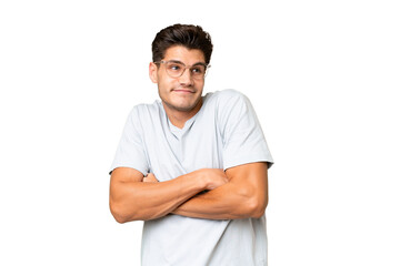 Young caucasian handsome man over isolated background making doubts gesture while lifting the...