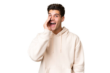 Young caucasian handsome man over isolated background shouting with mouth wide open