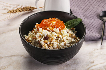 Curd with granola and orange jam