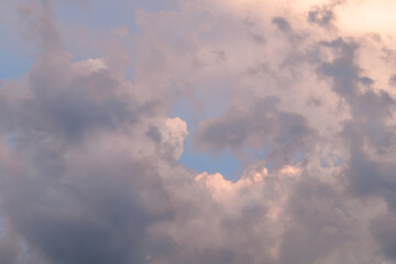 Clouds at sunset. Pink and yellow big clouds at sunset