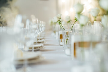 Elegant neutral coloured wedding table scape with flowers and candles