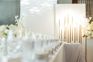 Elegant neutral coloured wedding table scape with flowers and candles