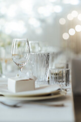 Elegant neutral coloured wedding table scape with flowers and candles