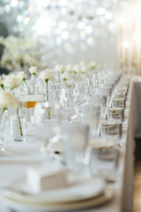 Elegant neutral coloured wedding table scape with flowers and candles