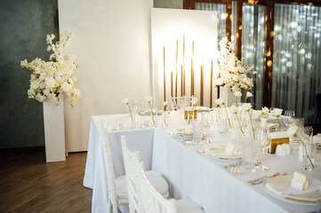 Elegant neutral coloured wedding table scape with flowers and candles