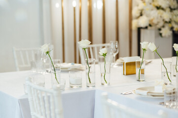 Elegant neutral coloured wedding table scape with flowers and candles