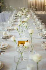 Elegant neutral coloured wedding table scape with flowers and candles