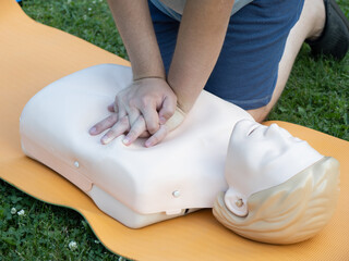 First aid training - mastering CPR techniques on a dummy