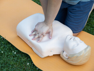 First aid training - mastering CPR techniques on a dummy