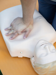First aid training - mastering CPR techniques on a dummy
