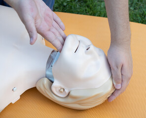 First aid training - mastering CPR techniques on a dummy