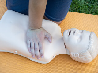 First aid training - mastering CPR techniques on a dummy