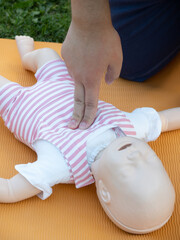 First aid training - mastering CPR techniques on a dummy