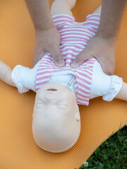 First aid training - mastering CPR techniques on a dummy