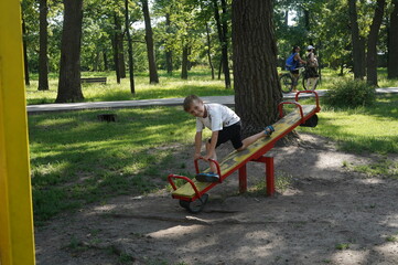 child, girl on the playground, on the ground with toys, baby on the ground playing with sand, motherhood, toys, summer, spring, doll, beautiful daughter, childhood, playground, fun, kid, boy, park, pl