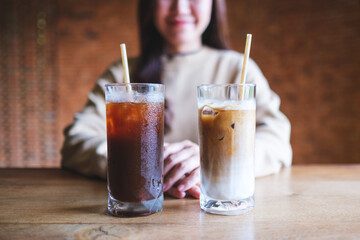 Closeup image of a young woman with two glasses of iced coffee