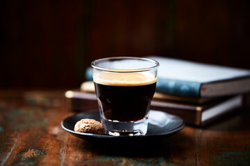 Coffee in glass cup on dark background. Close up. Copy space.