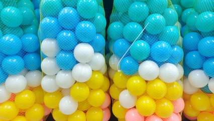 A Pile Of Colorful Plastic Balls Hanging In A Net Basket