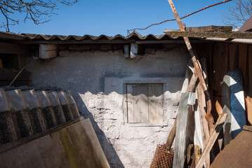 A fragment of a barn wall with a small window