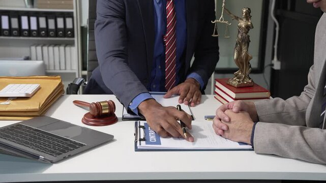 A collaborative office meeting around a desk involves teamwork, with a focus on financial charts and discussions on legal rights, liberty, autonomy, and empowerment in decision-making