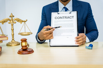 A male Asian lawyer in a formal suit handles contracts, agreements, legal obligations, and...