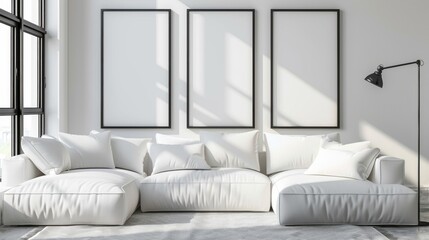 A white living room with three black framed pictures on the wall