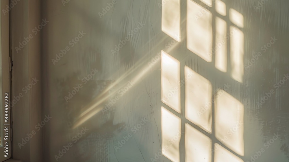 Poster sunlight streams through a window, casting a grid of light on a wall