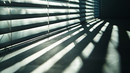 Obraz premium Sunlight streams through blinds, casting stripes of light across a darkened room