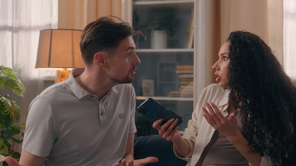 Upset angry couple arguing quarrel phone addicted jealous sms woman argument family problem...