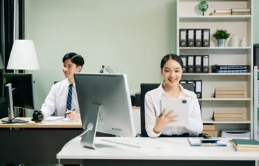 Fototapeta premium Business woman using tablet and laptop for doing math finance on an office desk, tax