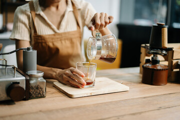 Asian barista brewing fresh espresso. Enjoy a cozy, trendy cafe experience with high quality beans in home or cafe
