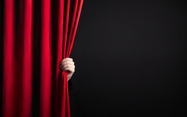 hand open red stage curtain on black background