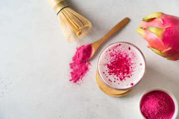 Pink matcha latte with powder on white background