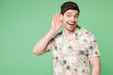 Young curious nosy Caucasian smiling cheerful man he wear shirt casual clothes try to hear you...