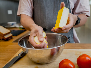 Chef at the kitchen preparing tofu scramble with vegetables