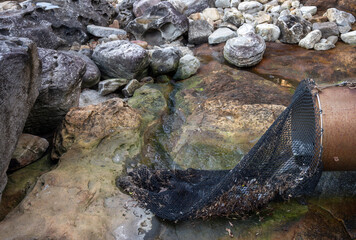 net attached to drained pipe for catching rubbish before draining water to the sea protecting environment
